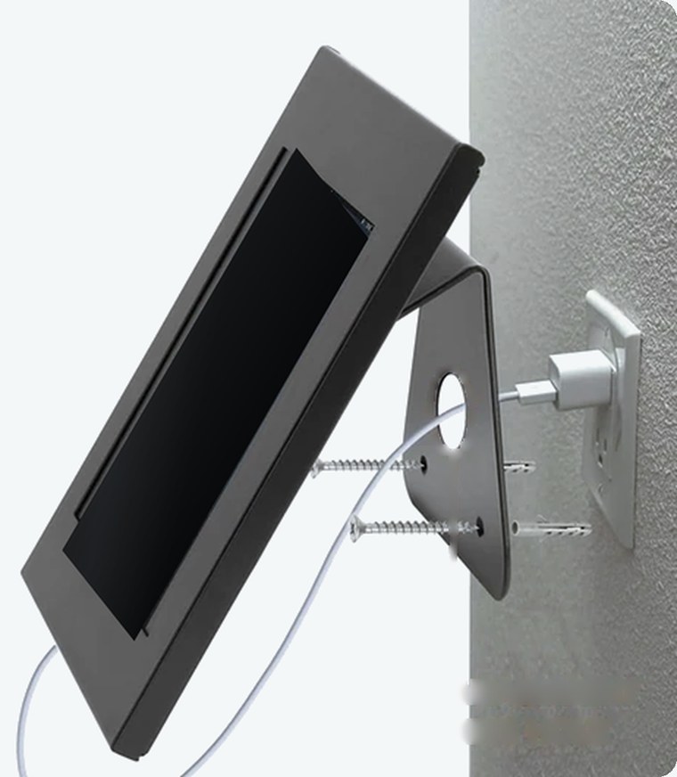 Kiosk stand mounted to a wall, with the charging cable through the base
